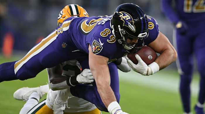 Dec 19, 2021; Baltimore, Maryland, USA; Baltimore Ravens tight end Mark Andrews (89) dives forward as Green Bay Packers defensive back Chandon Sullivan (39) defends during the first quarter at M&T Bank Stadium.
